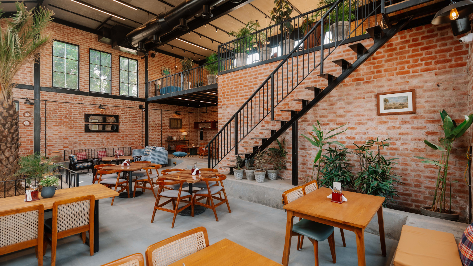 The Barnyard Co. — main dining hall with staircase and brick walls