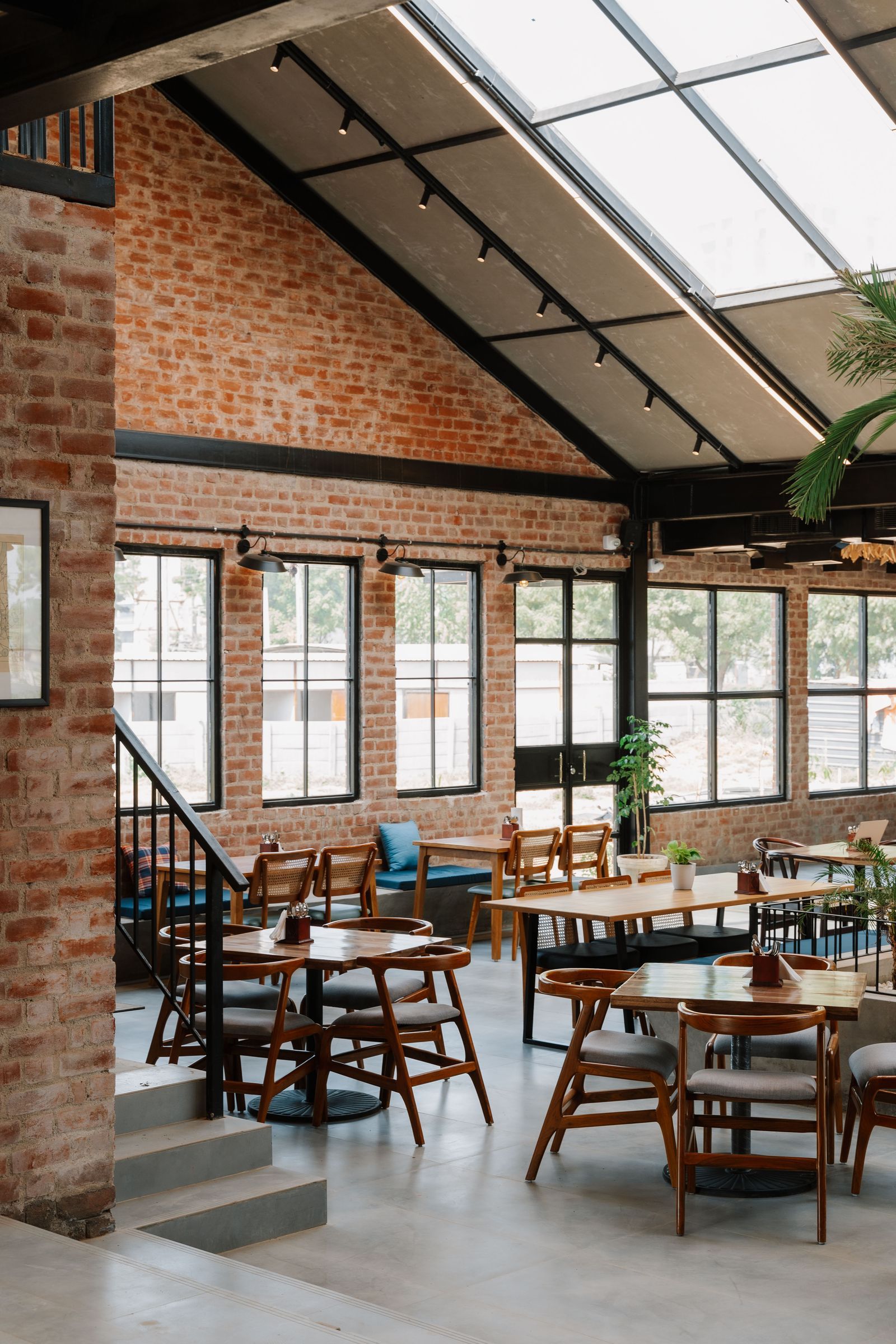 The Barnyard Co. — industrial loft interior with skylights and dining area